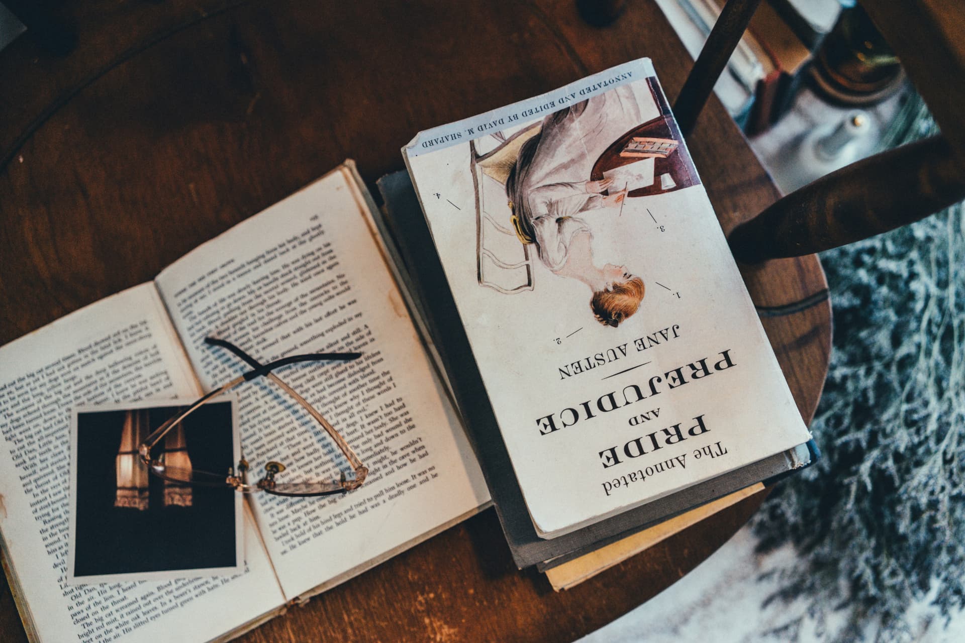 Annotated edition open on a table beside reading glasses